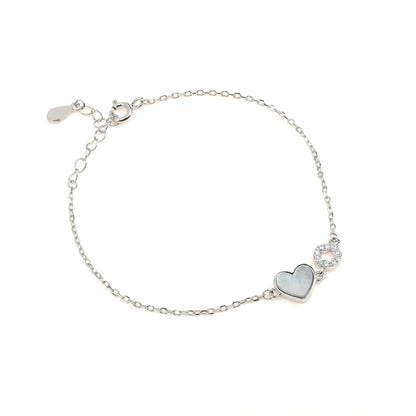 white heart-shaped charm and a round  studed charm 925 sterling Silver Bracelet